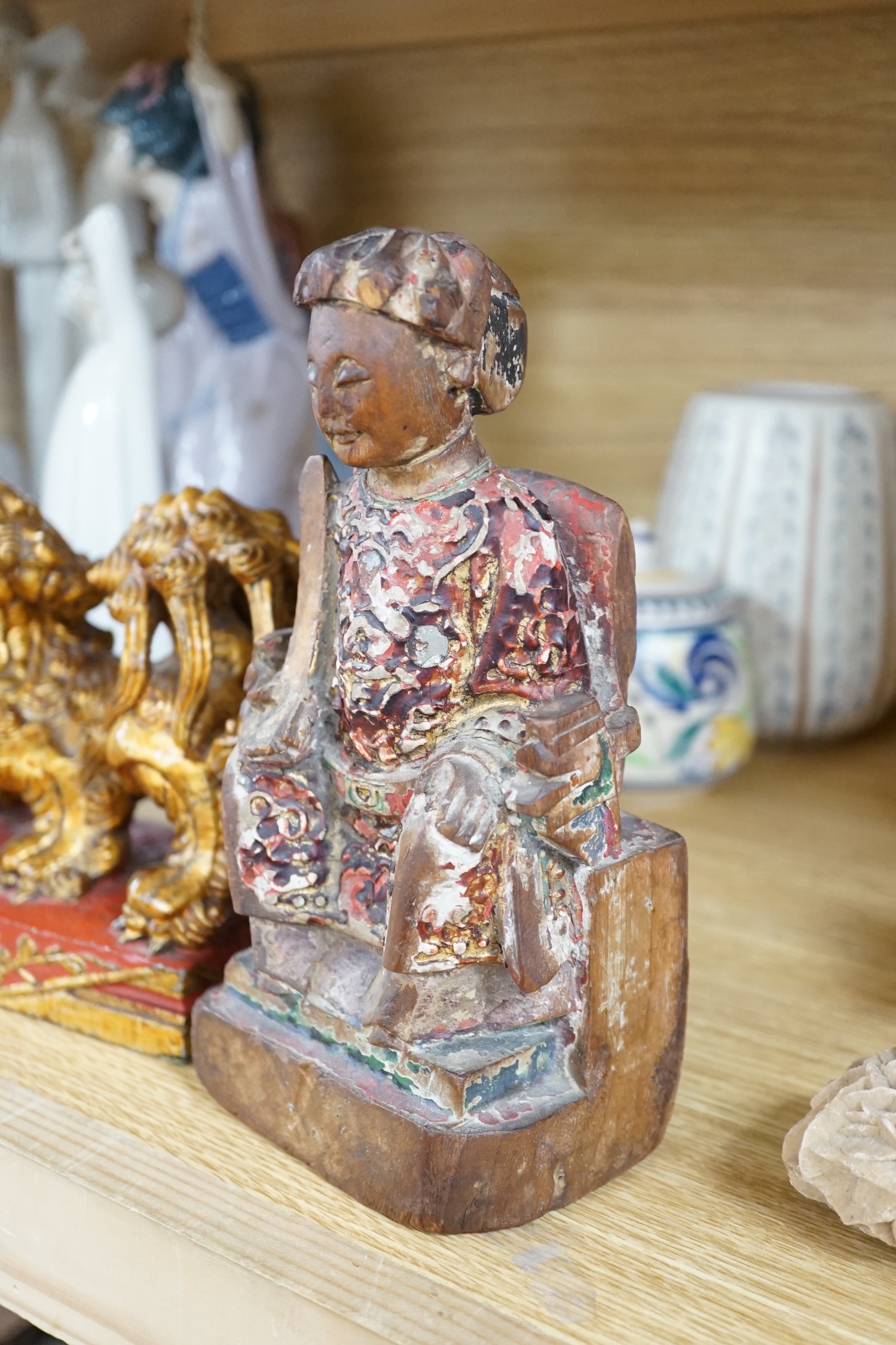 A Chinese lacquered wood figure of a seated woman and a Buddhist lion, tallest 20.5cm